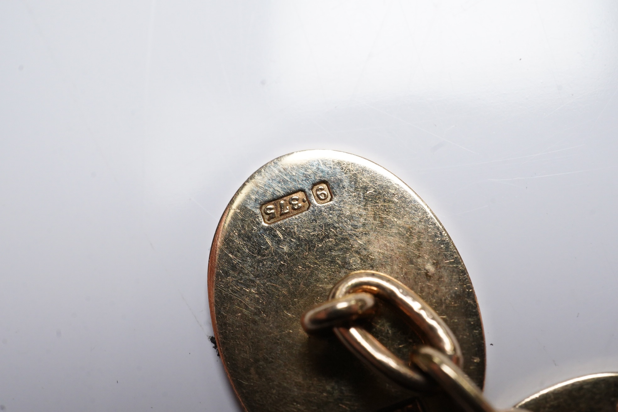 A pair of 1970's engraved 9ct gold oval cufflinks, 18mm, 11 grams. Condition - fair to good